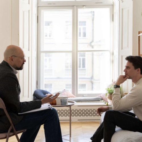 A coach and client talking during a one-to-one session
